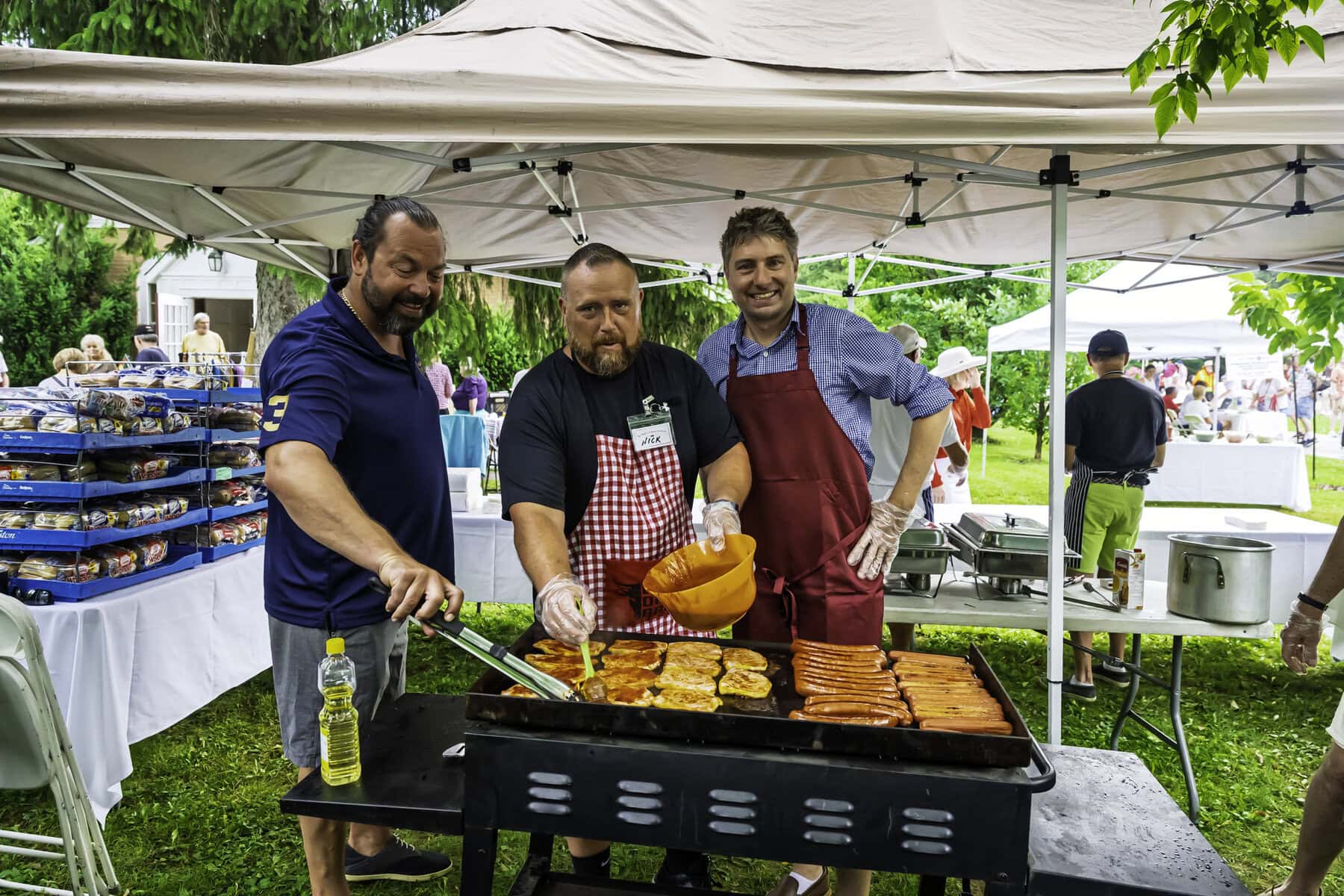 Over at the barbecue station, a few of the folks who represent the town: Coun. Tim Balasiuk, CAO Nick Ruller and Coun. Andrew Niven grill up some hamburgers and hot dogs to feed the crowd of festivalgoers.