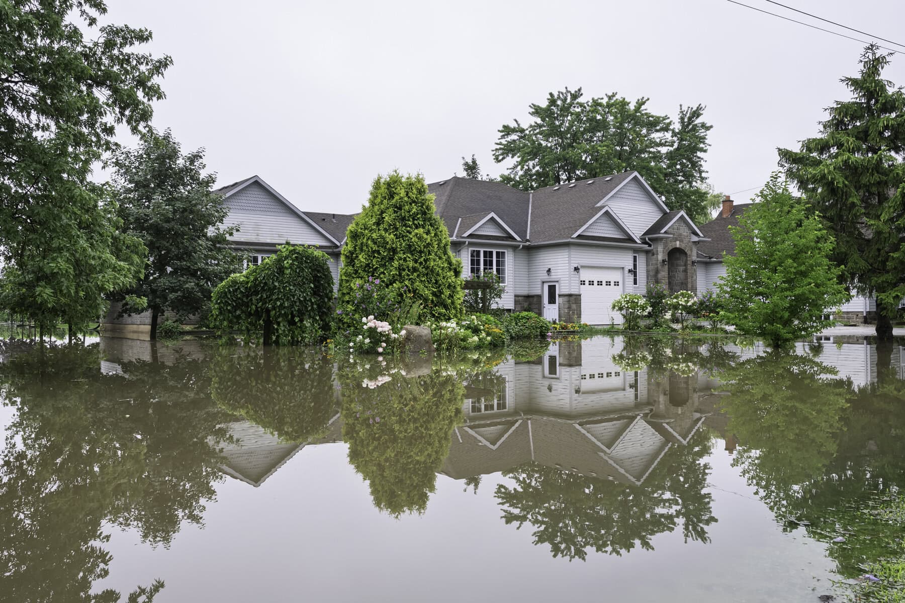 Stormwater floods the lawn of this home at 853 Line 2 Road.