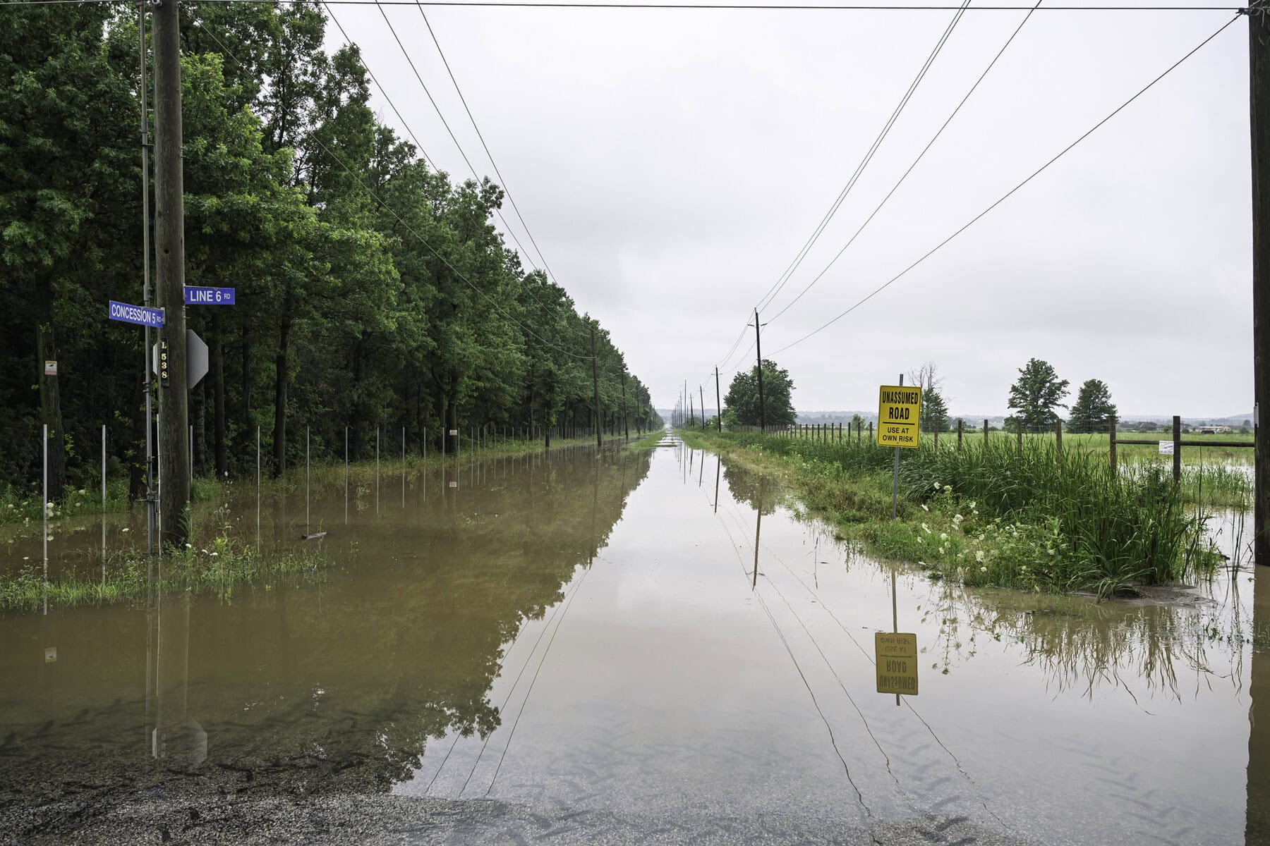 The intersection of Concession 5 and Line 6 roads, where water is rising high over the road.