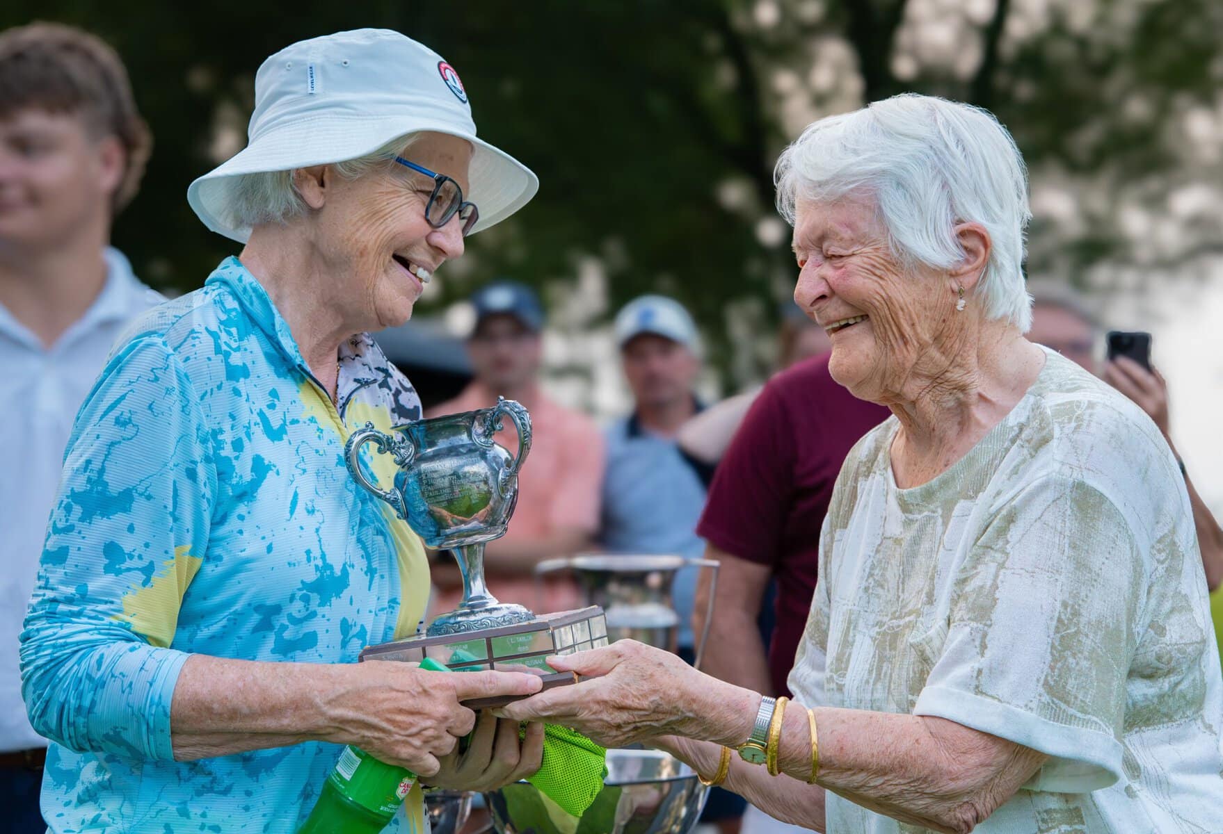 Ginny Green, who won the women's B flight in a playoff, receives her trophy from Barbara Ahluwalia.
