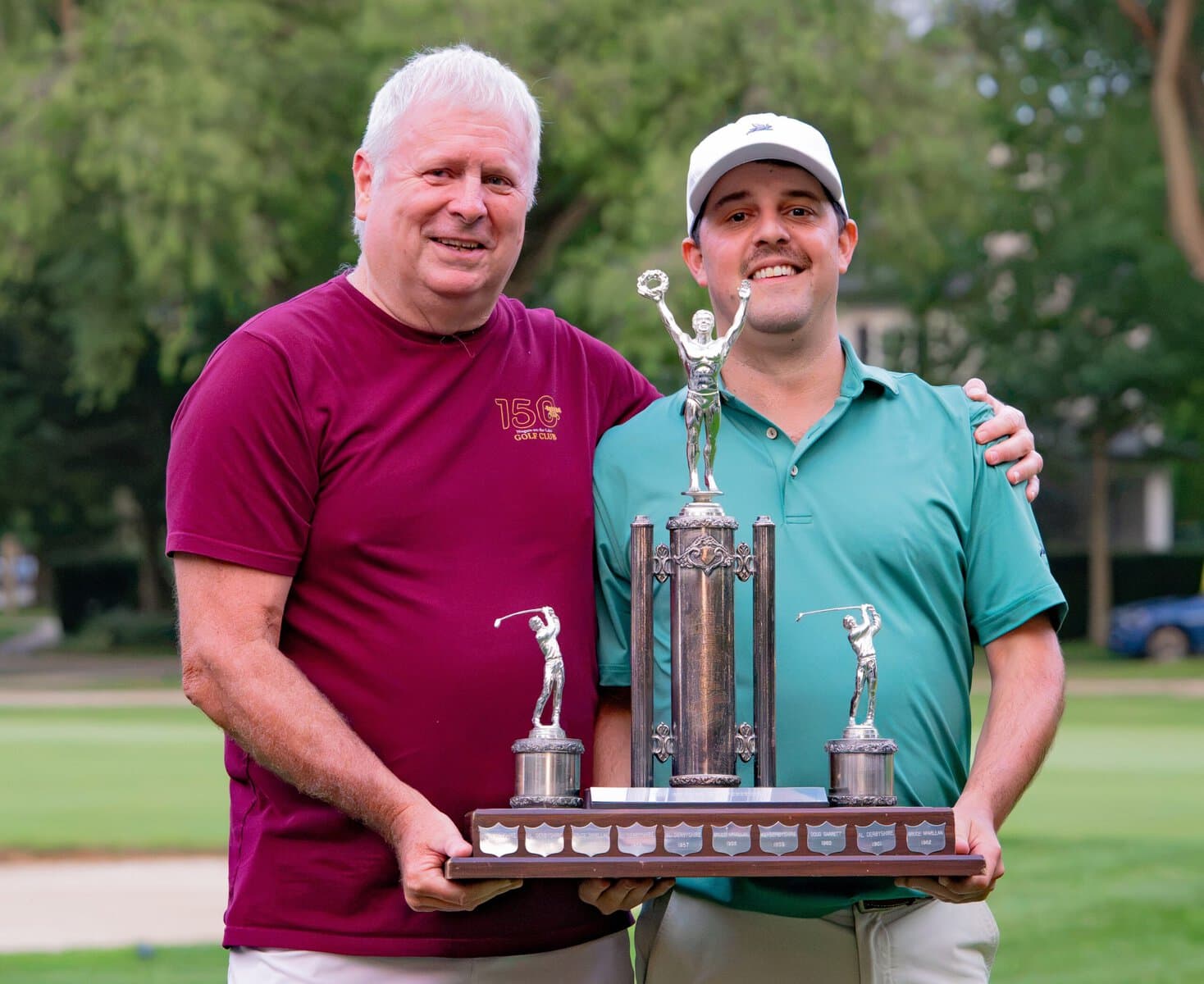 Mark Derbyshire, left, a 33-time champ, presents this year's winner, Ricky Watson, with his trophy.