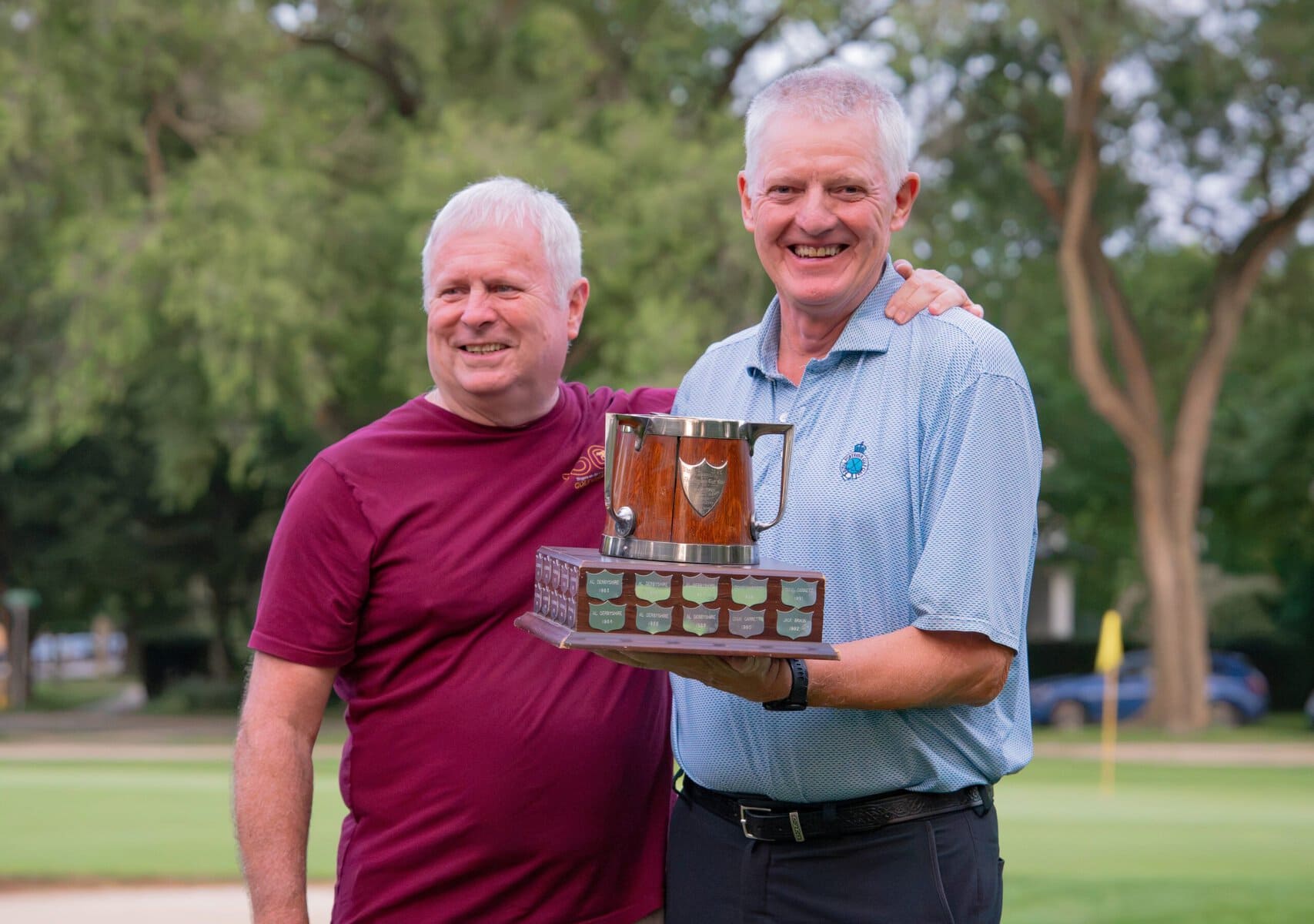 Mark Derbyshire, left, congratulates senior men's champ Paul Dickson.