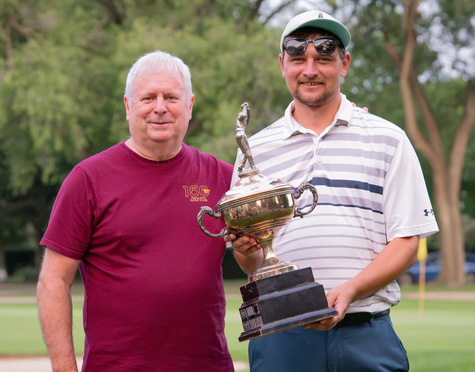 Men's Open runner-up and A flight champioin James Grigjanis-Meusel receives his trophy from Mark Derbyshire.