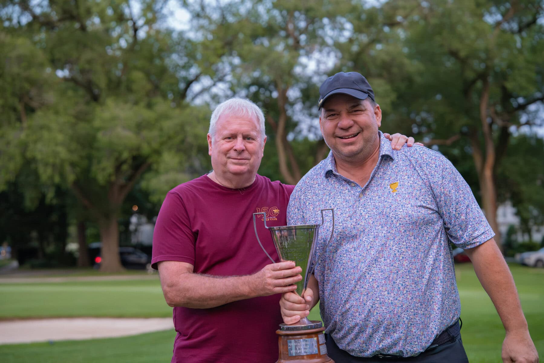 Rob Chubey, who won the men's C flight, receives his trophy from Mark Derbyshire.