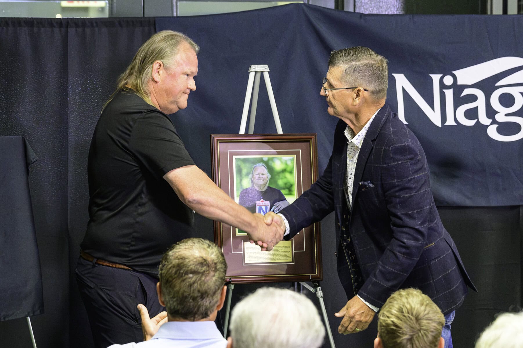 Ken Rive, chair of the Sports Wall of Fame committee, congratulates Kurt Hamm on his induction. "Sport matters," Rive said. "Games end, but the impact of sport lasts a lifetime."