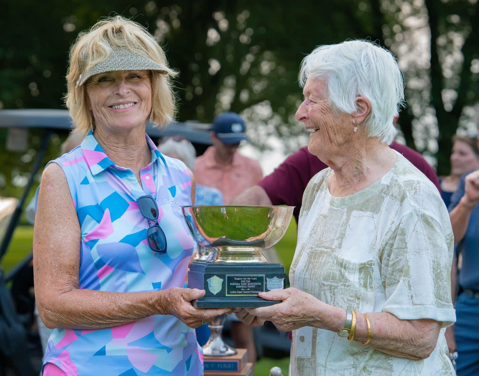 Women's super seniors champ Martha Cruikshank receives her trophy from Barbara Ahluwalia.
