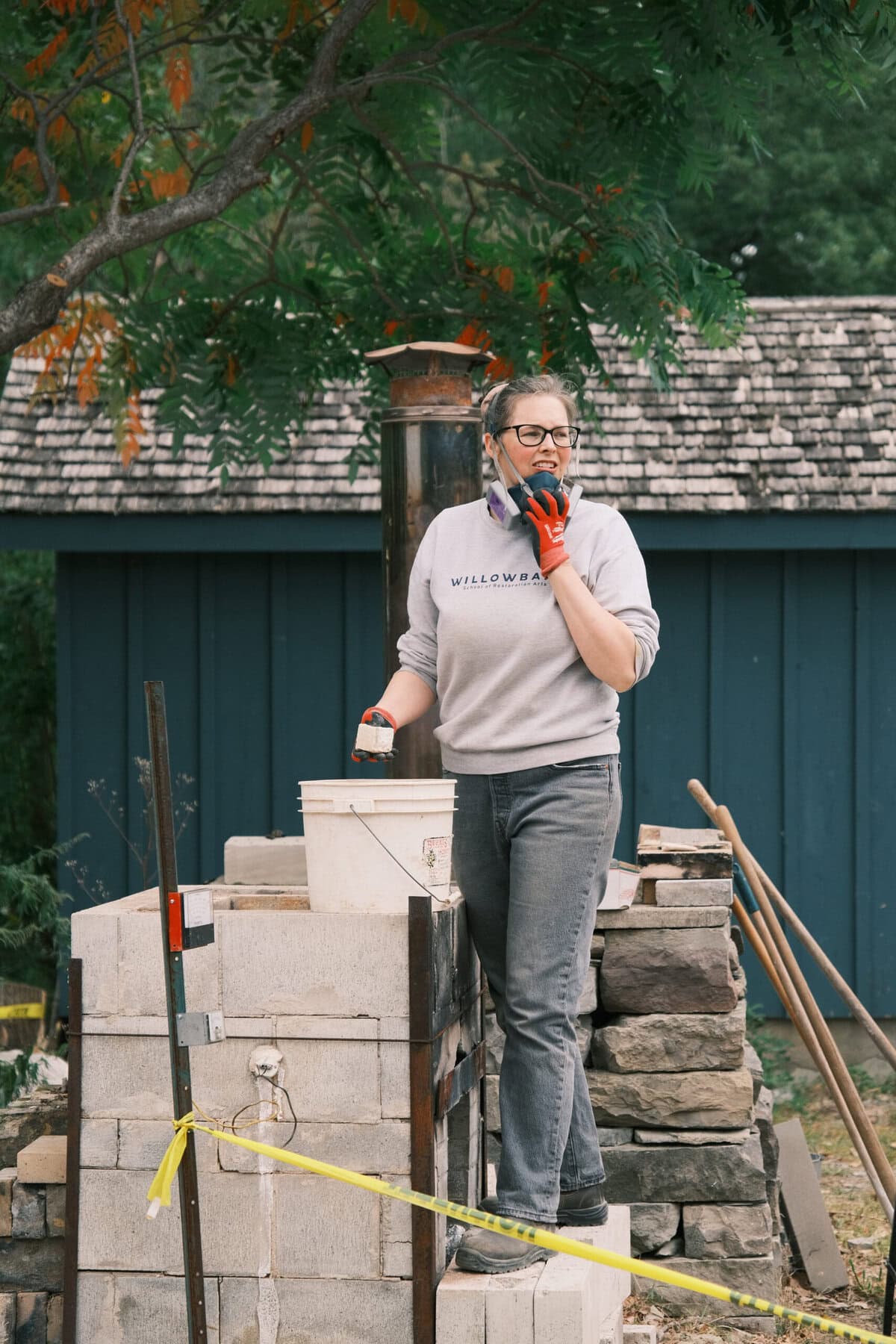 Willowbank alum and faculty member Alex Blades unloads the fired limestone in preparation for slaking lime – the next step in the lime preparation process.