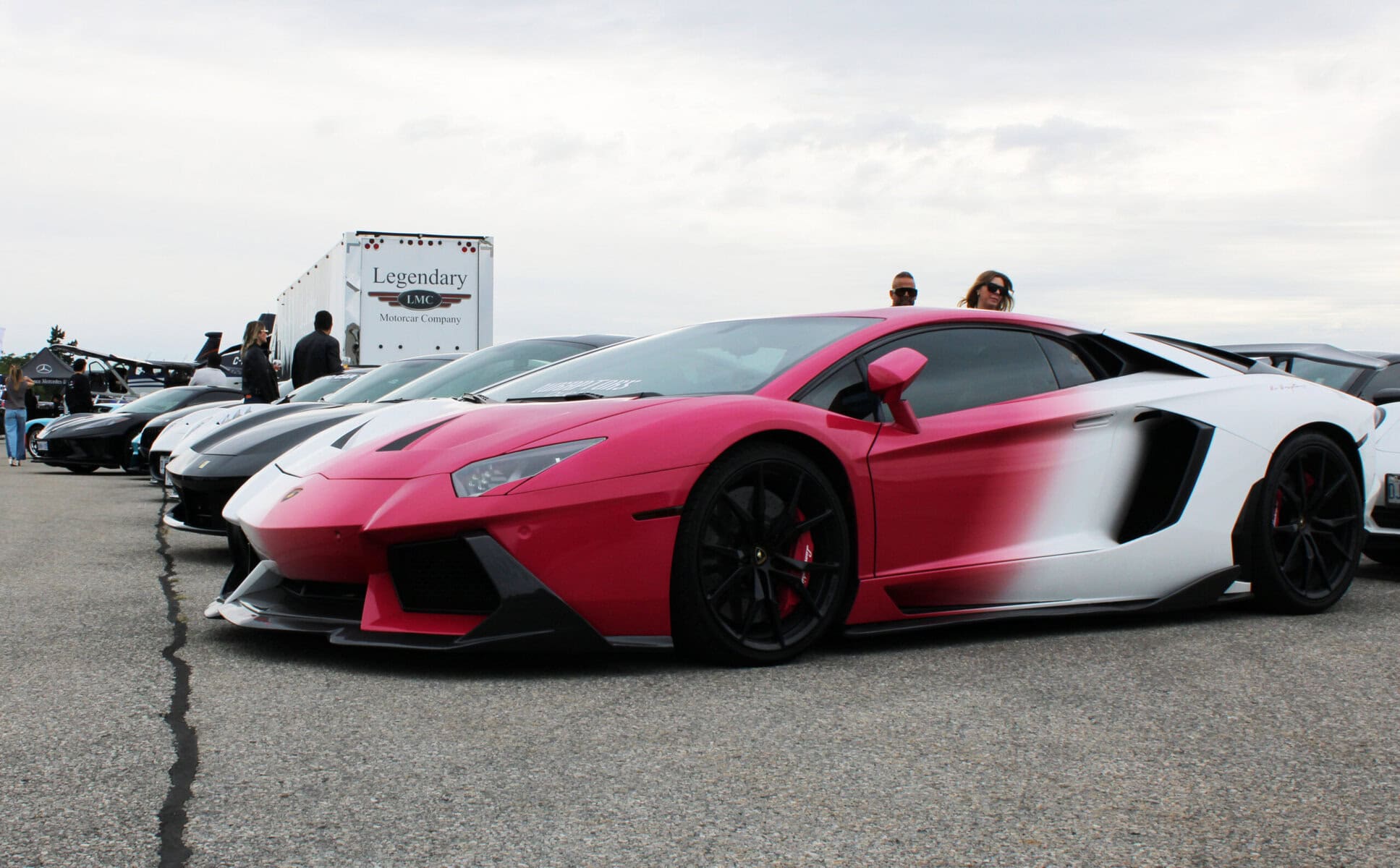 Guests walk the row of supercars parked outside the hangar at Niagara District Airport, where more than 500 ticket holders spent Saturday afternoon among Lamborghinis and Ferraris.