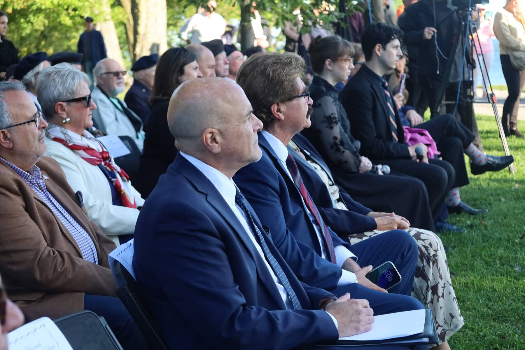 Tony Baldinelli, member of Parliament for Niagara Falls—Niagara-on-the-Lake, sits next to Wayne Gates, member of provincial Parliament for Niagara Falls, as speakers recount their memories of Sept. 11, 2001, and what the 25th anniversary of the attacks mean to them.