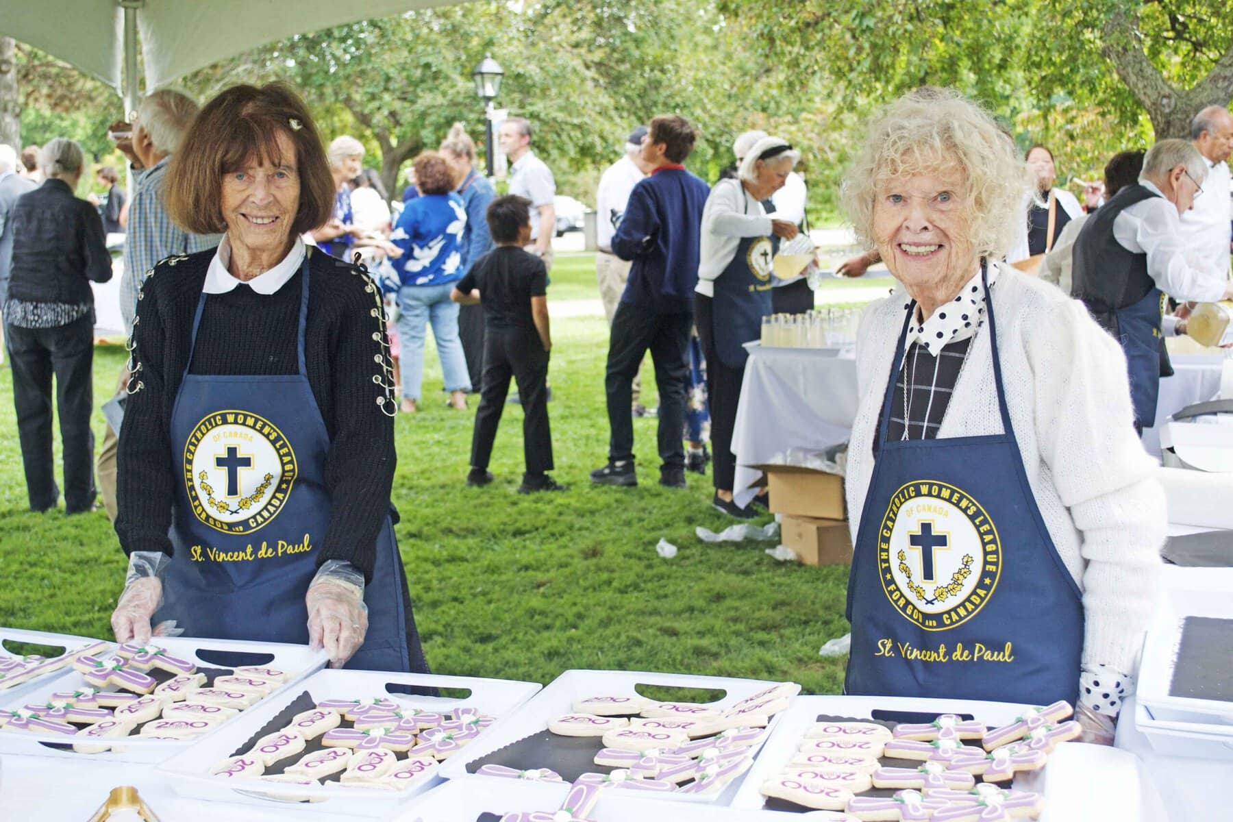 Beatrice and Kathleen Maloney handed out anniversary cookies to guests and parishioners. 