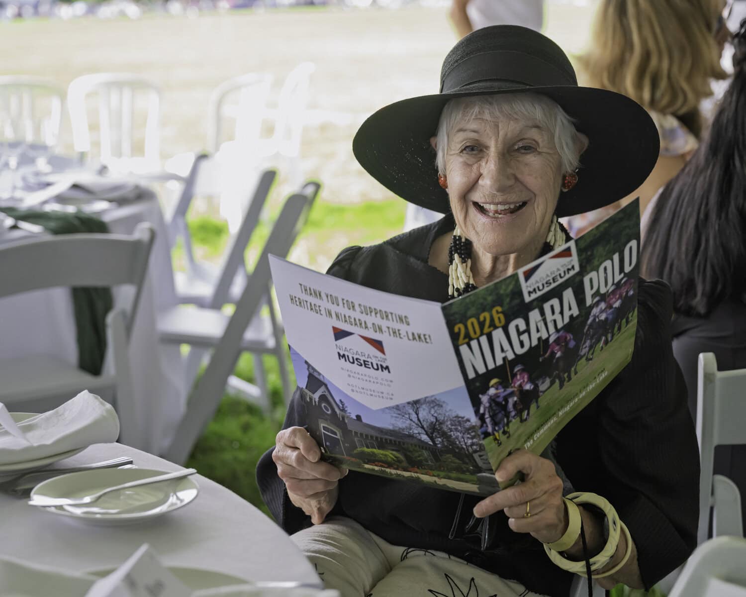 Leslie Jones peruses the program for Niagara Polo 2026. This fundraiser supports the Niagara-on-the-Lake Museum and comes around once every two years.