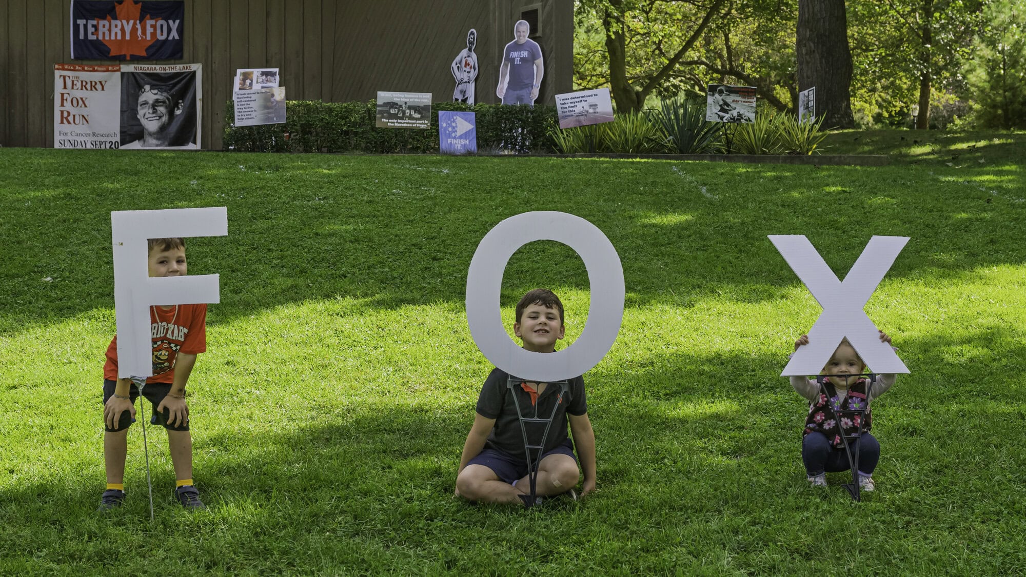 The Taylors — Ben, 4, Wesley, 6, and Cora, 18 months — hold up the three letters making up Terry Fox's last name, a name etched into Canadian history more than four decades ago.