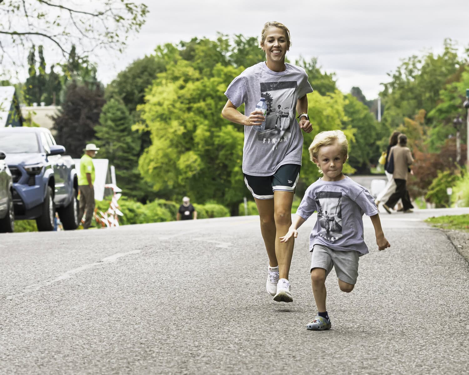 Katherine Sparrow runs with four-year-old Brooks Taylor, who's giving it his all.