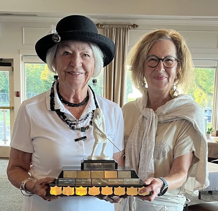 Carole Matheson, left, receives the Joy Nelles Trophy from Deborah Williams. 