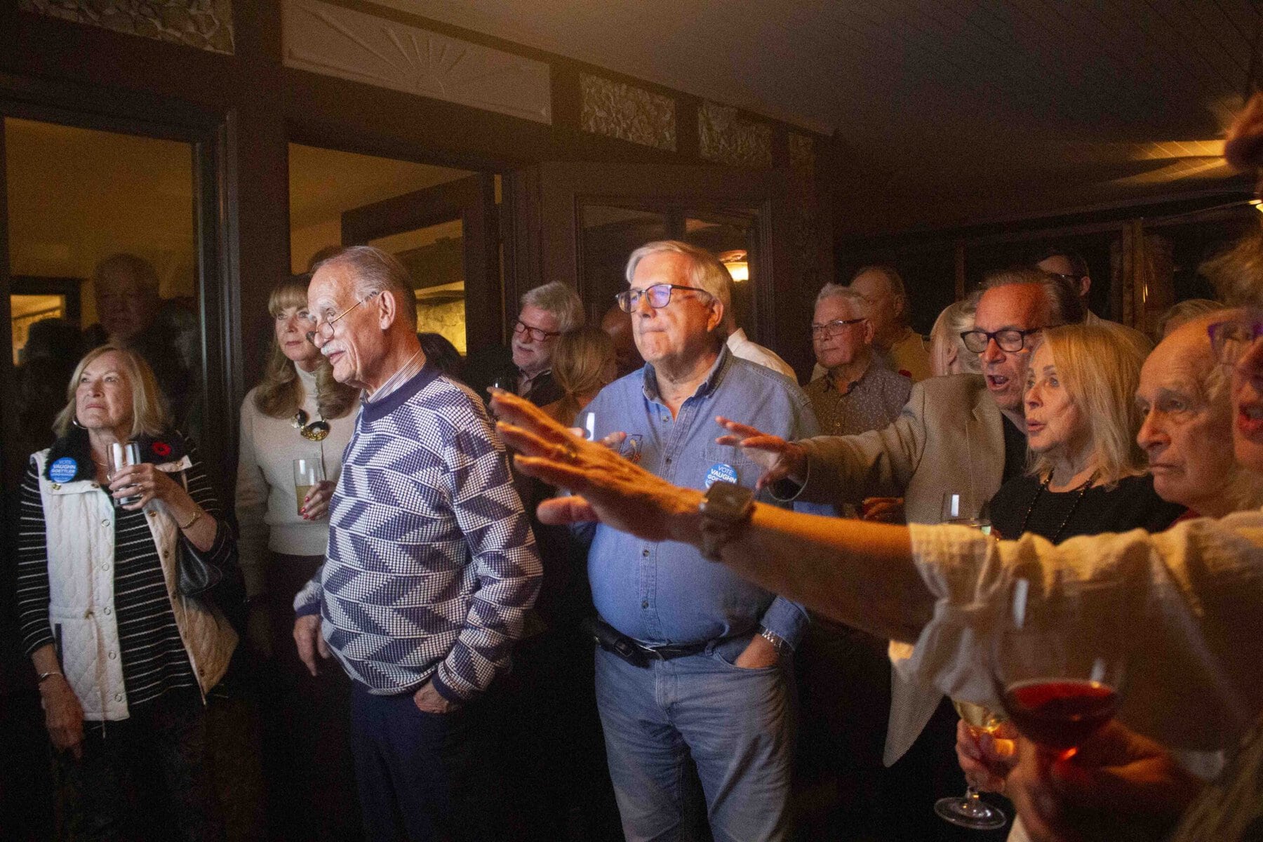 A crowd eagerly watches as results start to come in, showing Goettler with a commanding lead from the get-go.