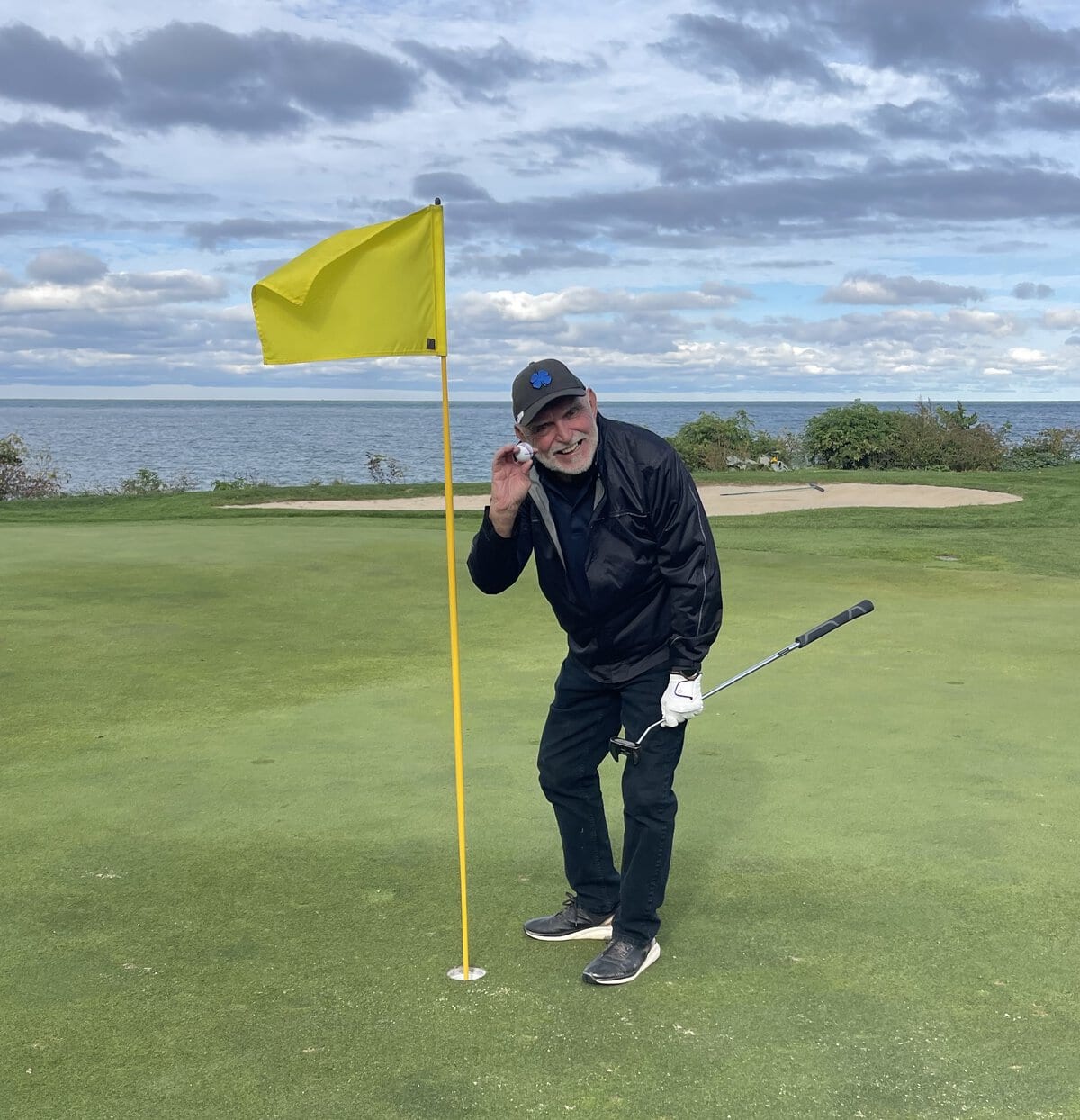 Joe Interisano collects his ball from the cup on the fourth hole after notching an ace. 