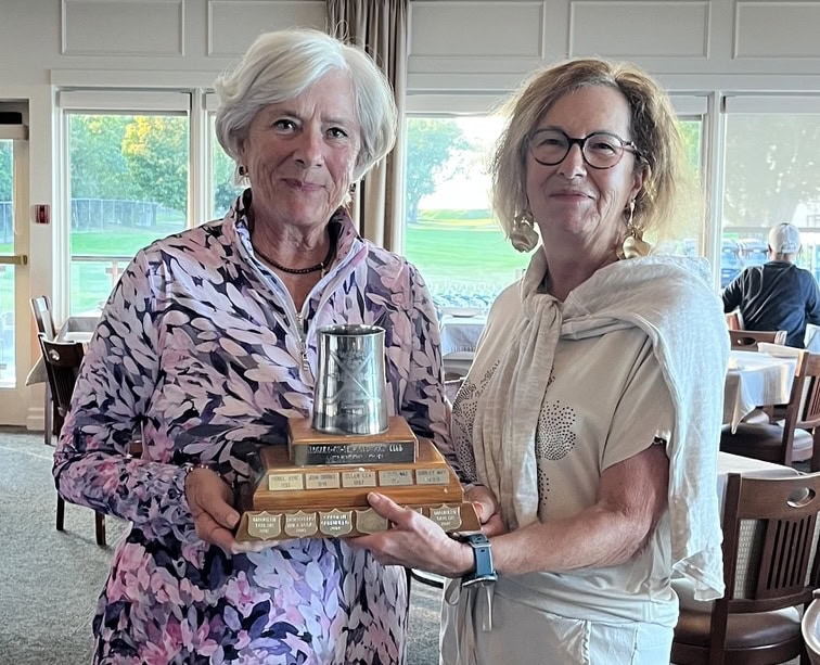 Sharron Marlow, left, is presented with the Carmichael Cup by Deborah Williams. 