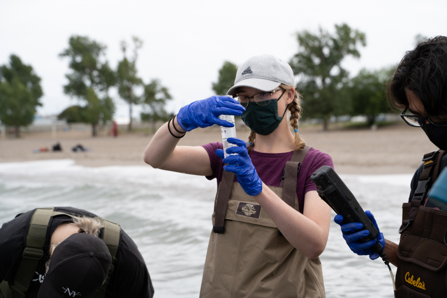 A volunteer takes a water sample in Lake Ontario (JESSICA GORDON photo).