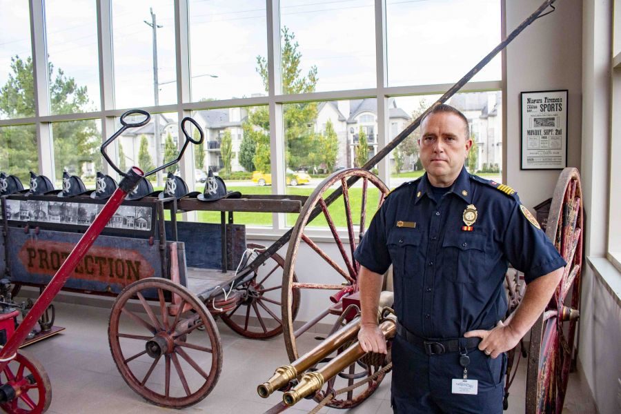 Fire_chief_Nick_Ruller_stands_with_vintage_fire_fighting_equipment_from_the_1800's_on_display_at_the_fire_station_in_Old_Town._(Evan_Saunders)