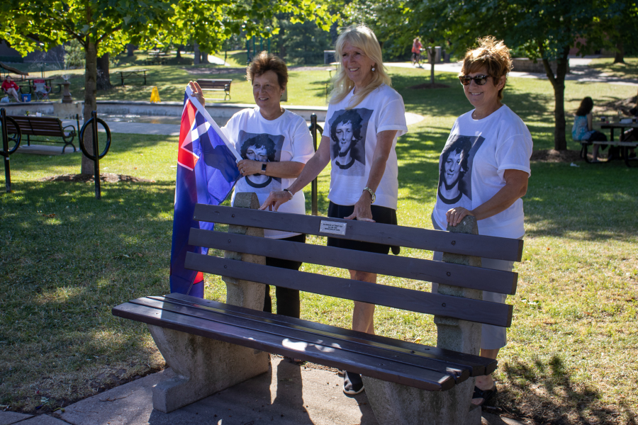 Lord Mayor Betty Disero, left, Joan King and Donna Sattin stand behind a bench in Simcoe Park dedicated to Terry Fox.