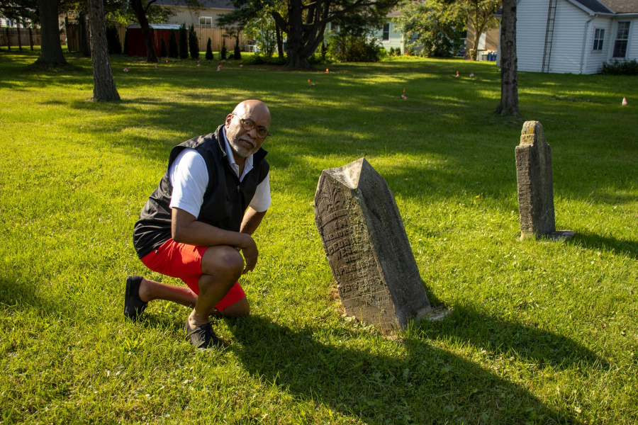 George Webber kneels next to the grave of George Wesley at the Niagara Baptist Church
Burial Ground, historically known as the Negro Burial Ground.