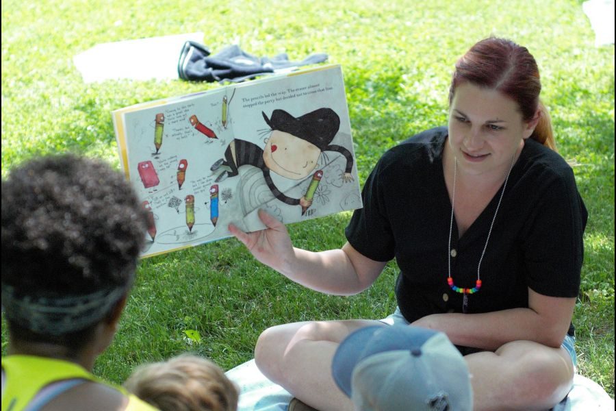 Kasia_Dupuis_reads_Arts_Supplies_by_Chris_Tougas_to_the_kids_in_the_park._Brittany_Carter