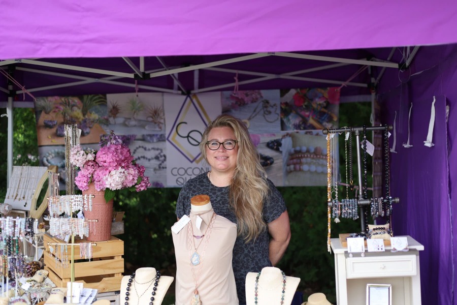 Owner of Coconut Quarts, Cheryl Chiarelli, with her stand set up at the Art at the Pumphouse.jpg