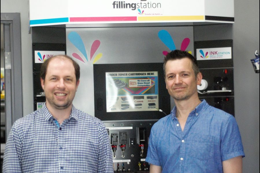 Ryan_Bridgeman_and_Dennis_Den_Besten_stand_with_the_new_printer_ink_refill_machine_-_the_onlyone_of_its_kind_in_NOTL._Brittany_Carter
