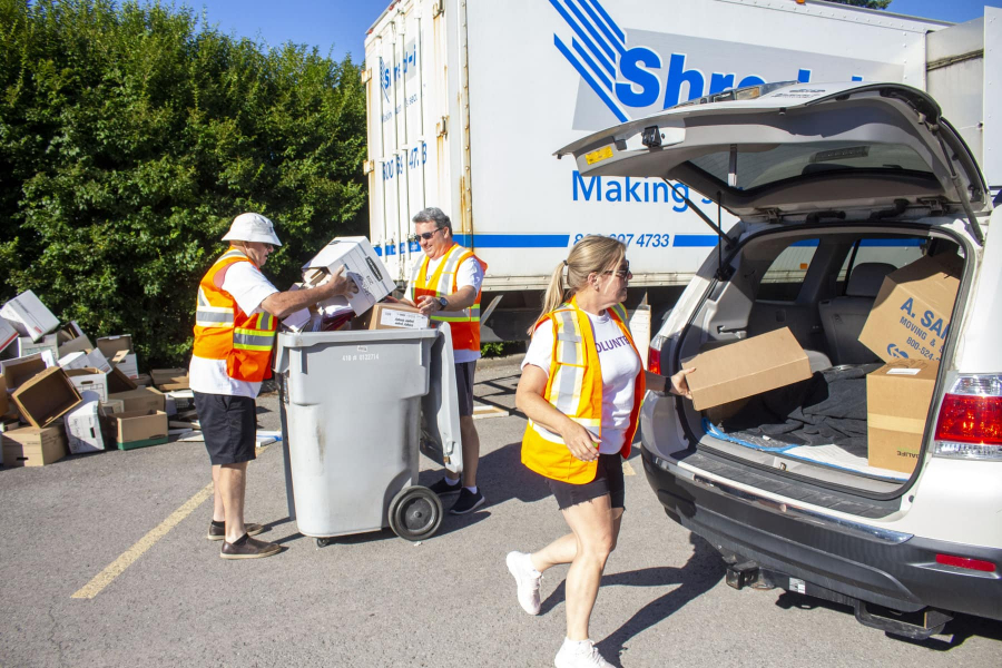 Bonnie Bagnulo, executive director of NOTL Palliative Care, helps take boxes of documents out of vehicles during the 'Shred-it' fundraiser Aug. 15.