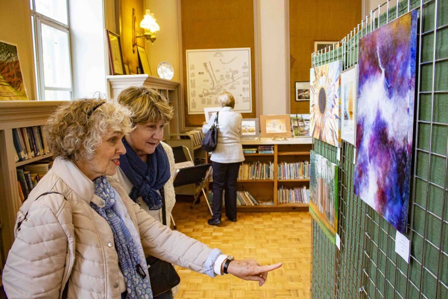 Susan_Brown_and_Marlene_McCarthy_admire_some_of_the_paintings_on_display_at_the_Queenston_Library_over_the_long-weekend._Evan_Saunders