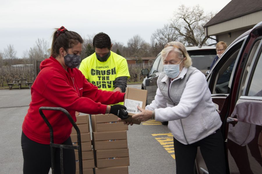 United_Way_Niagara_volunteers_Krista_Butters_and_Daryl_Crosby_and_Sean_Simpson_load_protein_bars_into_delivery_vehicles