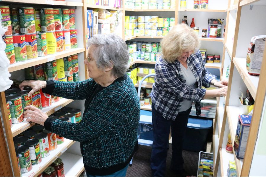 Volunteers Brenda Shah and Marilyn Rickard sort donations at the Newark Neighbours food bank.