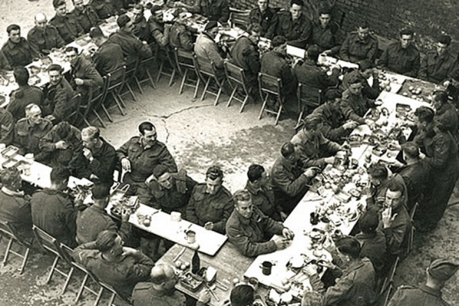 Members of the Seaforth Highlanders sit down for their Christmas dinner.